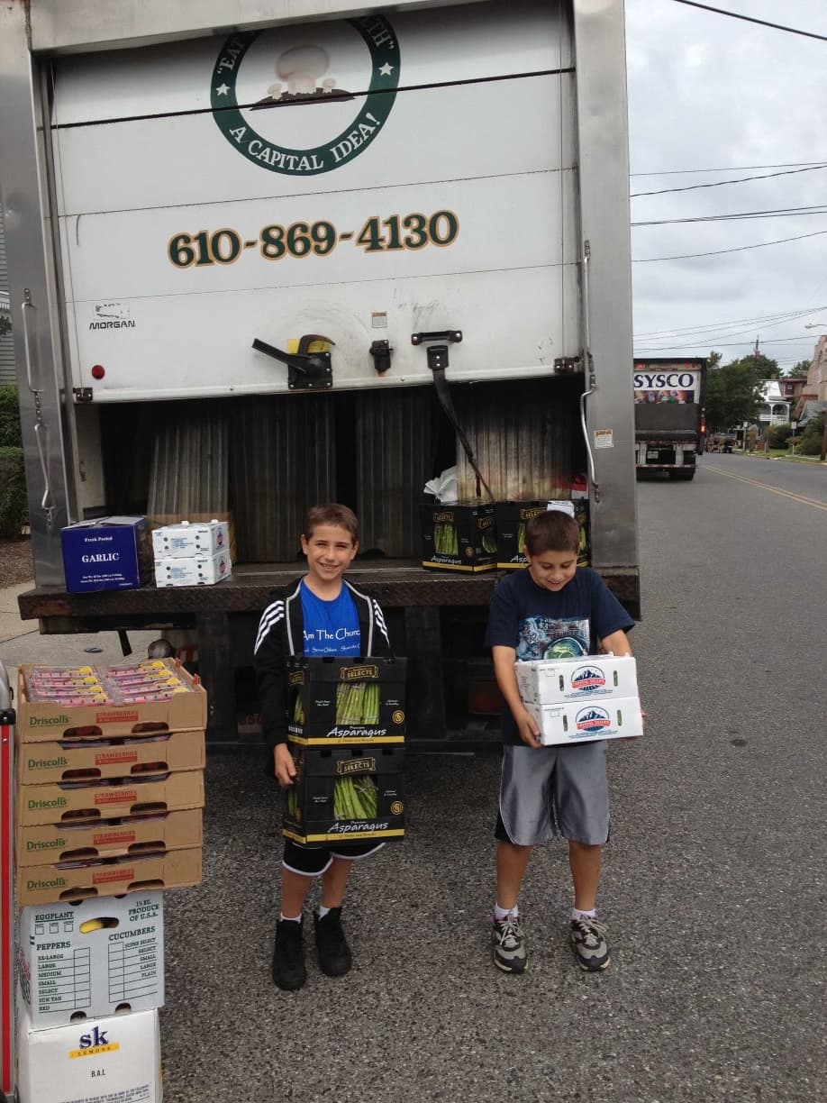 Timo founder Joe Starkey, left, and his brother at a Capital produce delivery